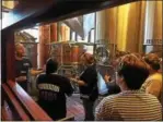  ?? SUBMITTED PHOTO ?? Iron Hill Brewery & Restaurant Head Brewer Will Mink, at left, leads a tour of the Phoenixvil­le brewing process for Kimberton Fire Company members. Iron Hill will release Tower 61 beer next week during an event that will benefit the fire company.