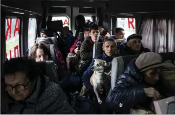  ?? EVGENIY MALOLETKA — THE ASSOCIATED PRESS ?? People sit in a bus during evacuation from Lyman, Donetsk region, eastern Ukraine, on Saturday.