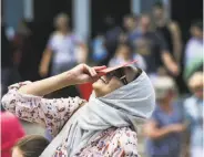  ?? Michael Ciaglo / Houston Chronicle ?? HOUSTON: Rabia Safdar catches the show at the Houston Museum of Natural Science, where the eclipse was a partial one.