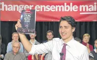  ?? CP FILE PHOTO ?? Prime Minister Justin Trudeau displays a Liberal platform document during an election campaign appearance in 2015.