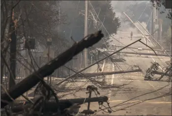  ?? BRIAN VAN DER BRUG/LOS ANGELES TIMES ?? Power poles and lines block a street at Brookdale and Aaron Drive in Hidden Valley, where most of the homes were destroyed by fire, on Oct. 9 in Santa Rosa.