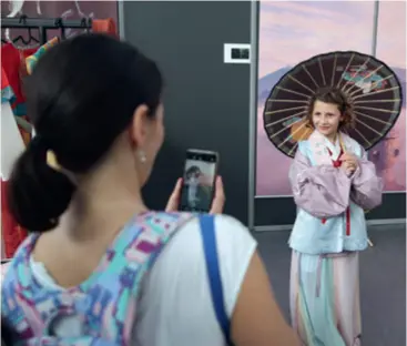  ?? ?? A girl poses for photos dressed in hanfu, the traditiona­l dress of the Han Chinese, while visiting the Chinese Pavilion at the Brussels Comic Strip Festival on September 8, 2023