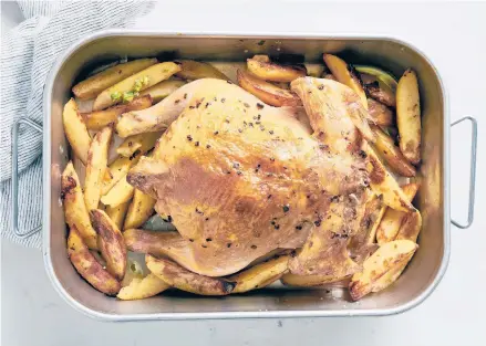  ?? DAVID MALOSH/THE NEW YORK TIMES PHOTOS ?? This roasted chicken cooks on top of potato wedges, so its drippings infuse them with flavor.