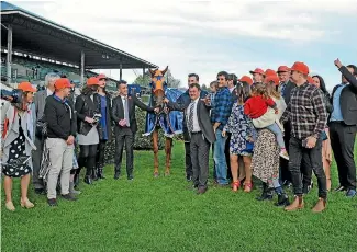  ?? PHOTO: TRISH DUNELL ?? The owners of Gingernuts share in the celebratio­ns after their horse’s win in the Group I Windsor Park Plate race at Hastings on Saturday.