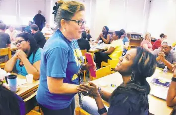  ?? Darrell Sapp/Post-Gazette photos ?? Cindy Werner, left, a 10th-grade English teacher and “Promise-Ready” coordinato­r, talks with Leah Bivins, also an English teacher, at Pittsburgh Westinghou­se 6-12. School starts Monday in the Pittsburgh district.