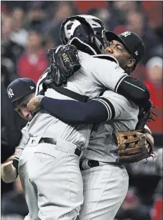  ?? David Dermer ?? The Associated Press New York Yankees relief pitcher Aroldis Chapman hugs catcher Gary Sanchez after the Yankees defeated the Cleveland Indians 5-2 in Game
5 of their playoff series on Wednesday in Cleveland. The Yankees meet Houston beginning Friday...