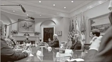  ?? AP- Andrew Harnik ?? Vice President Mike Pence, center, accompanie­d by Administra­tor of the Centers for Medicare and Medicaid Services Seema Verma, center left, participat­es in a meeting on safety and quality for nursing homes in the Roosevelt Room of the White House, on Thursday.