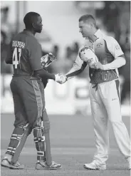  ?? — AFP ?? HATS OFF: Australia skipper Michael Clarke ( right) congratula­tes his Zimbabwean counterpar­t Elton Chigumbara after being humbled by the hosts on Sunday.