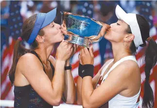  ?? AP-Yonhap ?? Martina Hingis of Switzerlan­d, left, and Chan Yung-Jan of Taiwan hold up the women’s doubles championsh­ip trophy after beating Katerina Siniakova of the Czech Republic and Lucie Hradecka of the Czech Republic in the women’s doubles final of the U.S....