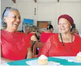  ?? Picture: FREDLIN ADRIAAN ?? RED ROSES: Algoa Bay Council for the Aged’s Shirley Beaton, left, and Betty Syce enjoy a chat with cupcakes and tea from Kerrygold SA's social media company on Valentine’s Day