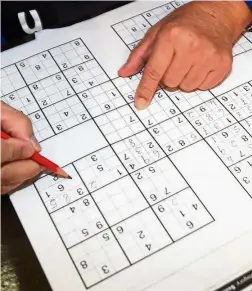  ?? — Filepic ?? Research has indicated that brain-stimulatin­g activities, like doing Sudoku, are linked to lower risk of dementia.