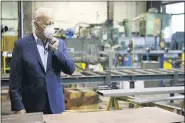  ?? MATT SLOCUM — THE ASSOCIATED PRESS ?? Democratic presidenti­al candidate, former Vice President Joe Biden adjusts his mask during a tour of McGregor Industries, a metal fabricatin­g facility in Dunmore, Pa.