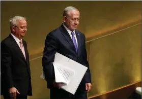  ?? AP Photo/Richard Drew ?? Addressing the assembly: Israel's Prime Minister Benjamin Netanyahu, right, carries his speech and visual aids to address the 73rd session of the United Nations General Assembly, at U.N. headquarte­rs, Thursday.