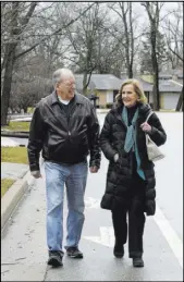  ?? Teresa Crawford The Associated Press ?? Bill Gurolnick walks with his wife, Peggy Bartelstei­n, near their home Tuesday in Northbrook, Ill. Gurolnick, who turns 87 in March, thinks his own stellar memory is bolstered by keeping busy.