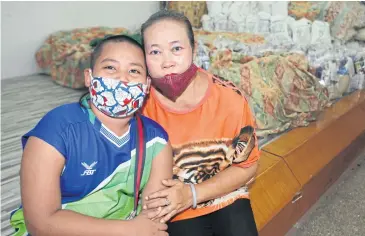  ??  ?? HARD TIMES: Malee Boonmee, 49, and her 10-year-old adopted son Nong Pi have been hit by the lockdown, after Ms Malee lost her job. Her family now has no income and she doesn’t know how she will support the education of her two sons when schools reopen in July.