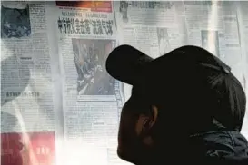  ?? ANDY WONG/AP ?? A man at a Beijing newsstand Monday reads about the government lodging a protest after the U.S. shot down a Chinese balloon, which landed off the South Carolina coast.