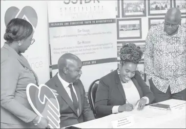  ?? ?? Magda Griffith-France (right), Founder/Executive Director, SSYDR signs the MOU in the presence of Venus Frith, General Manager- Credit,
RBGL and representa­tives from SSYDR and RB(G)L