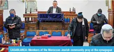  ??  ?? CASABLANCA: Members of the Moroccan Jewish community pray at the synagogue of Em Habanim on Jan 5, 2021. —AFP