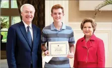  ?? Photo submitted ?? Ben Humphries (center), a senior at Siloam Springs High School, receives the Associatio­n Award for his watercolor titled, “The Freedom of Nature,” from Gov. Asa Hutchinson and First Lady Susan Hutchinson on April 24.