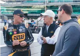  ?? DARRON CUMMINGS/AP ?? Roger Penske talks with Kevin Harvick and Kyle Busch following practice on Saturday at Indianapol­is Motor Speedway in Indianapol­is.