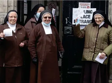  ??  ?? Ordered approach: Carmelite nuns on their way to ballot box at Dysart Community Hall