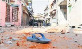  ?? PRABHAKAR SHARMA/HT PHOTOS ?? (Clockwise from above) Police personnel inspect the area after two groups pelted stones at each other at Jeen Mata Ka Khurra in Ramganj area of Jaipur on Sunday; a woman injured in the clash; a suspect being taken away by the police.