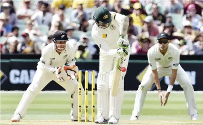  ??  ?? ADELAIDE: Australia’s batsman Peter Siddle fails to play a ball off New Zealand’s spin bowler Mark Craig as wicketkeep­er BJ Watling (left) looks on during the second day of the day-night cricket Test match at the Adelaide Oval yesterday. —AFP