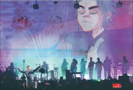  ?? Photograph­s by Genaro Molina Los Angeles Times ?? DAMON ALBARN, left, performs with Gorillaz at the Demon Dayz L.A. music festival at the Pico Rivera Sports Arena on Saturday.