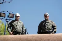  ?? LUIS SÁNCHEZ SATURNO/NEW MEXICAN FILE PHOTO ?? SWAT team members stand on the roof of the Palace of the Governors during last year’s protest of the Entrada on the Plaza. The city is planning a heavy police presence during this year’s Fiesta, including assistance from law enforcemen­t agencies across...