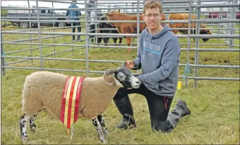  ??  ?? Jamie Maclean from Knock Farm, Mull, with Champion of Champions. 16_T32_Bunessansh­ow02