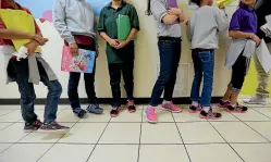  ?? AP ?? Migrant teens line up for a class at a ‘‘tender-age’’ facility for babies, children and teens, in Texas’ Rio Grande Valley, in San Benito.
