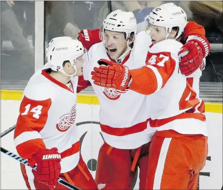  ?? — THE ASSOCIATED PRESS ?? Alexei Marchenko celebrates with Detroit Red Wings teammates Justin Abdelkader and Gustav Nyquist after scoring a goal against the Nashville Predators on Saturday.