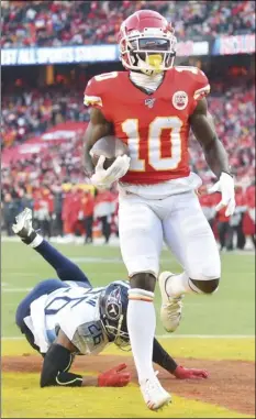  ?? AP PHOTO/ED ZURGA ?? Kansas City Chiefs’ Tyreek Hill scores a touchdown in front of Tennessee Titans’ Logan Ryan during the first half of the NFL AFC Championsh­ip football game on Sunday, in Kansas City, Mo.