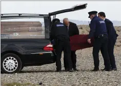  ??  ?? Gardaí and undertaker­s from Thomas Murphy & Sons taking the man’s body away from the beach in Bray last Thursday morning.