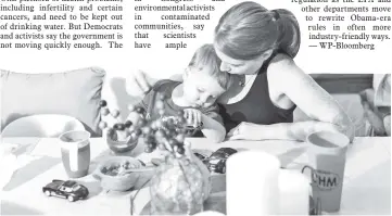  ??  ?? Sara Dean and her two-year-old son, Patrick, at their home in Parchment, Michigan, where water is contaminat­ed with PFAS. — WP-Bloomberg photo by David Kasnic