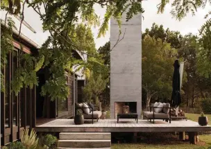  ??  ?? Left Lloyd likens the outdoor fireplace to resembling the lastremain­ing vestige of a long-gone house in the countrysid­e. The outdoor setting is ‘Alura’ by Royal Botania from ECC. The ceramic pots are from Morris & James.