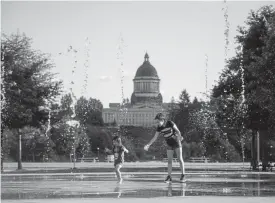  ?? Leah Nash, for The Washington Post ?? Heritage Park Fountain with Washington state’s Legislativ­e Building in background.