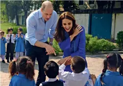  ?? AP ?? KIDS IN FOCUS: The royals interact with children at a school in Islamabad. —