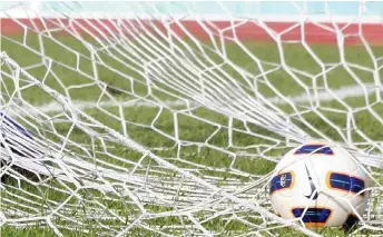  ??  ?? A ball is seen in the net during a football match. AFC general secretary Windsor John said he was confident that the AFC Champions League and AFC Cup would both be completed and did not rule out matches being played behind closed doors.