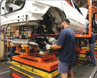  ?? Canadian press file photo ?? Workers are seen putting together a vehicle in General Motors’ CAMI Automotive facility in Ingersoll, Ont., in 2006. Officials say GM is cutting 625 jobs at the assembly plant near London, Ont.