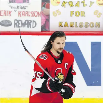  ?? PATRICK DOYLE /THE CANADIAN PRESS ?? Fans hold up signs in support of Senators captain Erik Karlsson during the warm-up before their game against the Winnipeg Jets at the Canadian Tire Centre on Monday evening.