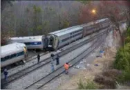  ?? THE ASSOCIATED PRESS ?? Authoritie­s investigat­e the scene of a fatal Amtrak train crash in Cayce, South Carolina on Sunday. At least two were killed and dozens injured.