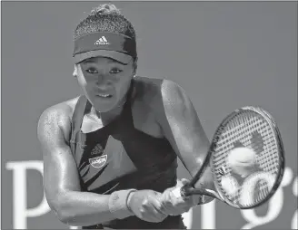  ?? AP PHOTO ?? Naomi Osaka, of Japan, returns a shot to Lesia Tsurenko, of Ukraine, during the quarterfin­als of the U.S. Open tennis tournament, Wednesday, in New York.