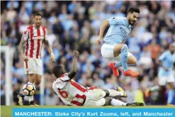  ?? — AP ?? MANCHESTER: Stoke City’s Kurt Zouma, left, and Manchester City’s Ilkay Gundogan battle for the ball