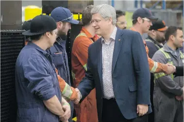  ?? DARRYL DYCK/The Canadian Press ?? Prime Minister Stephen Harper, with trade students in Delta, B.C. earlier this month, remains in contention to win a fourth
straight election despite the collapse of his three- pronged economic strategy — a testament to his political skills.