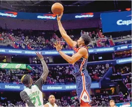  ?? KATHERINE FREY/ WASHINGTON POST ?? Washington’s Spencer Dinwiddie seals the Wizards’ win in double overtime over the Boston Celtics on Saturday in Washington, D.C. The Wizards won, 115-112.