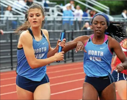  ?? BOB RAINES — DIGITAL FIRST MEDIA ?? Mikaela Vlasic takes the baton from Uche Nwogwugwu to begin the anchor leg of the 4x800 meter relay Friday.