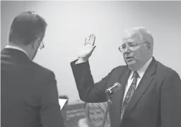  ??  ?? Corporatio­n Commission­er Andy Tobin, shown at his 2017 swearing-in, is looking a lot like a pocket pet for Arizona Public Service Co.