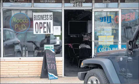  ?? KYLE TELECHAN/POST-TRIBUNE PHOTOS ?? Lianne Loving’s establishm­ent, Moods Pub in Portage, is open for business Thursday.