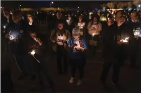  ?? (AP/Carolyn Kaster) ?? Community members, including Walmart employees, gather for a candleligh­t vigil Monday at Chesapeake City Park in Chesapeake, Va., for the six people killed at a local Walmart when a manager opened fire with a handgun before an employee meeting last week.